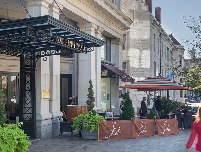 Fiola Building with woman and trees