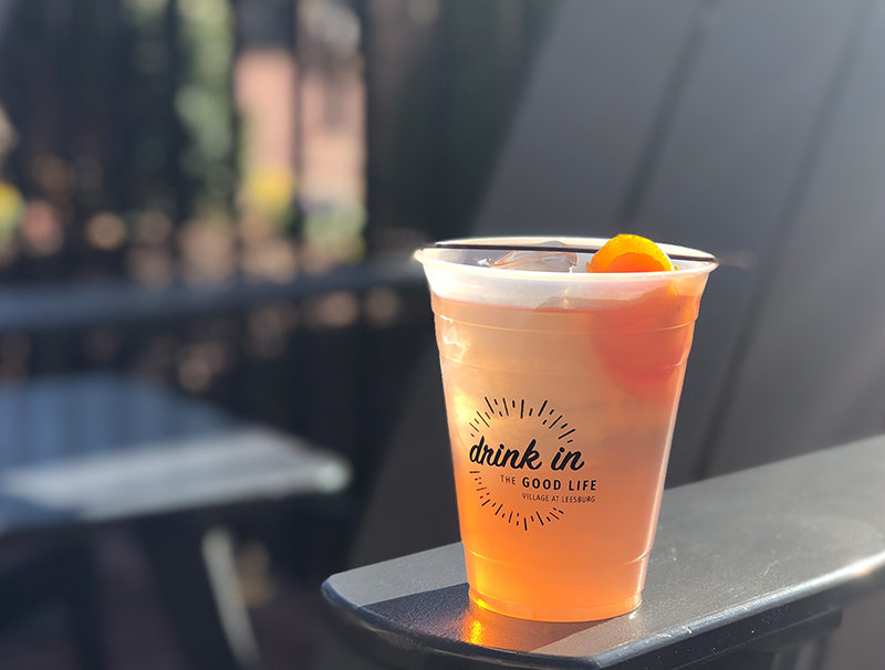 Orange cocktail in plastic cup