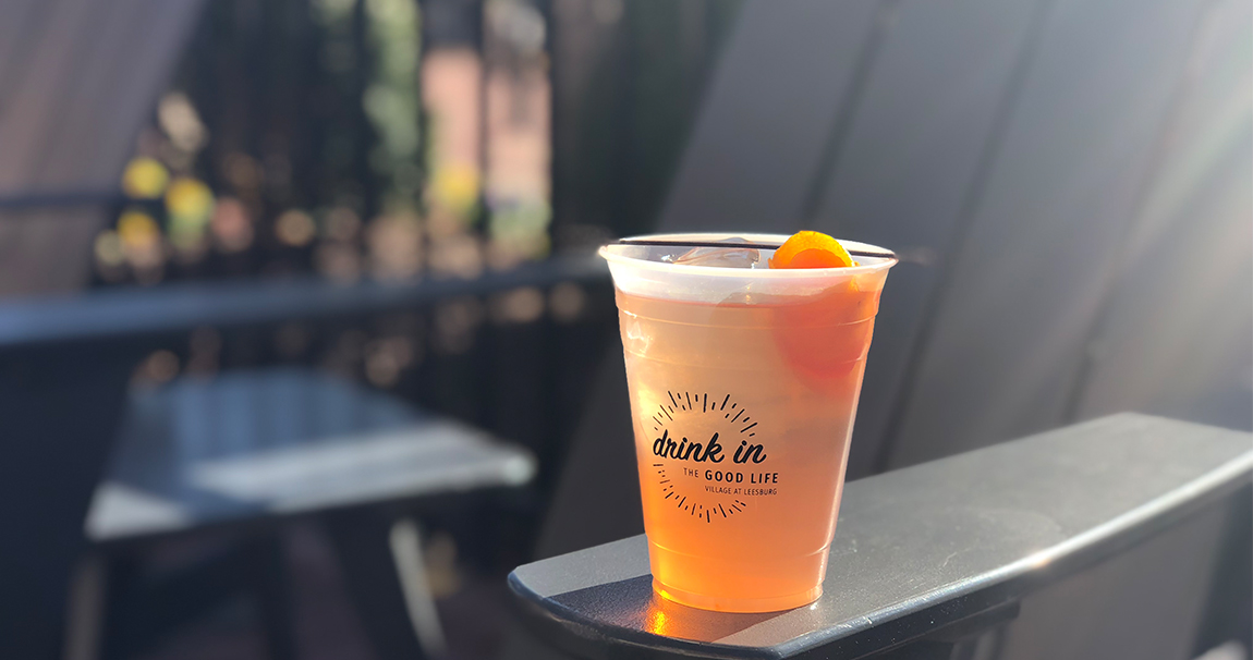 Orange cocktail in plastic cup