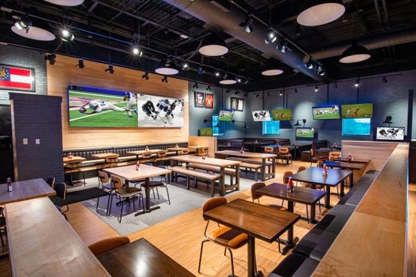 sports-bar-with-tvs-and-wooden-chairs-and-tables