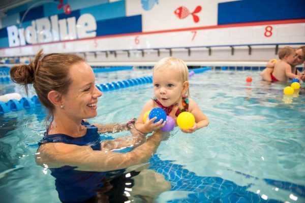 women-teaching-baby-how-to-swim-swimming-pool