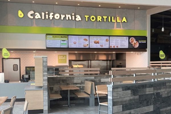 california-tortilla-sign-on-a-shop-with-grey-tiles-chair-tables