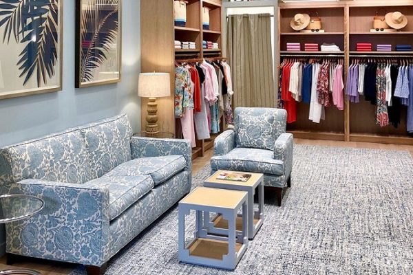 clothing-store-racks-of-clothing-blue-carpet-and-couches