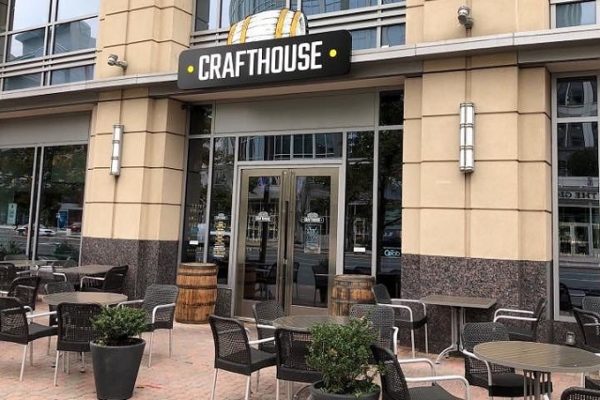 crafthouse-logo-sign-outside-building-black-chairs-and-tables