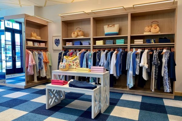 inside-of-clothing-store-racks-of-clothing-blue-and-white-carpet