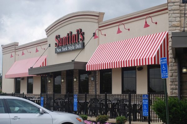 santinis-sign-on-building-with-red-and-white-banners-and-black-railing