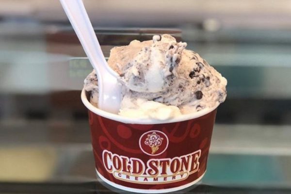 tub-of-icecream-with-spoon-on-glass-table