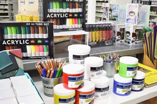 tubs-of-paint-pencils-andpens-on-table