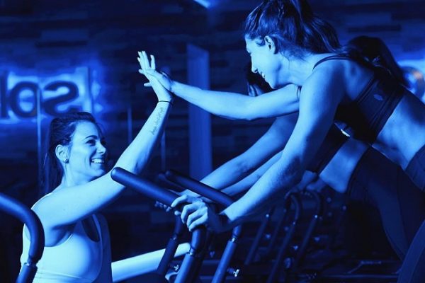 women-high-fiving-in-the-gym