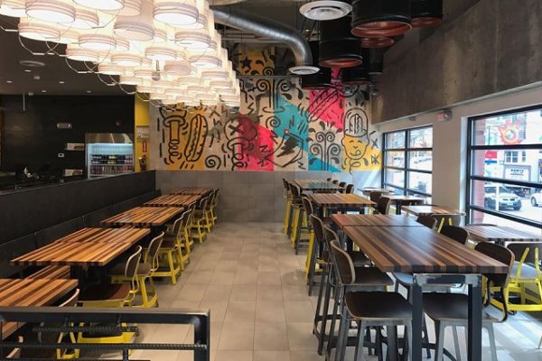 wooden-tables-yellow-chairs-restaurant-with-lights-and-painted-walls