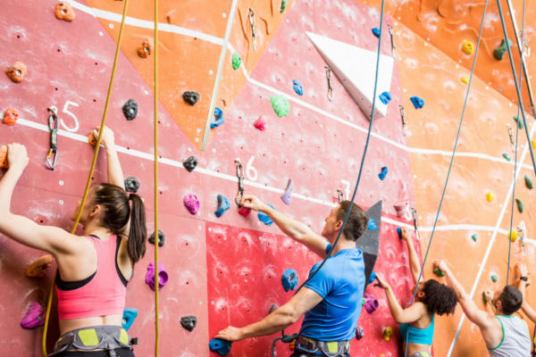 multiple-people-rock-climbing-indoors