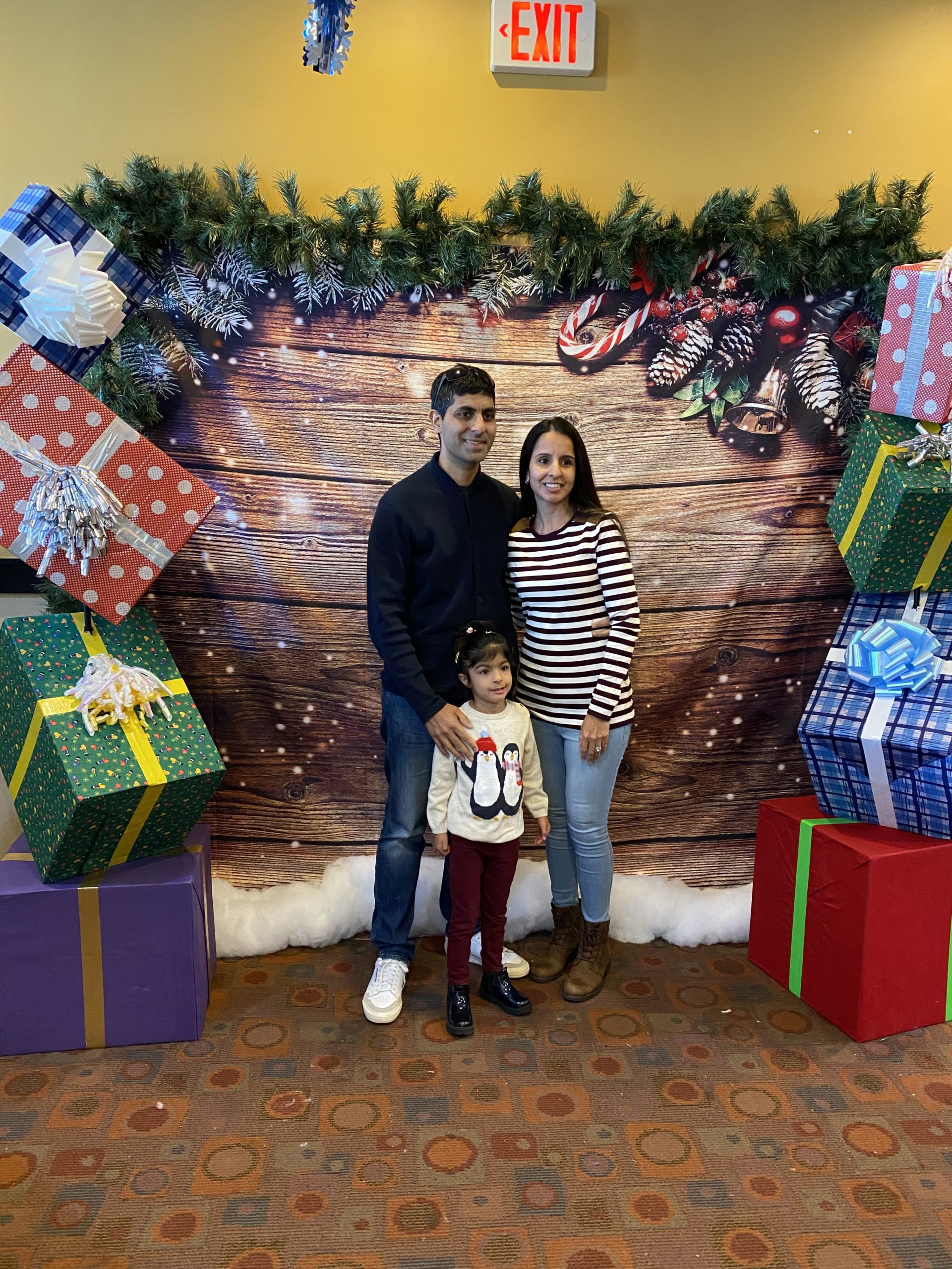 Couple and child posing with christmas background