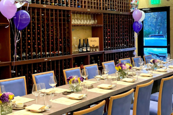 clarity_retailer_2 dining room with periwinkle dining room chair and purple balloons on the perimeter of the room, dining table is set with tableware