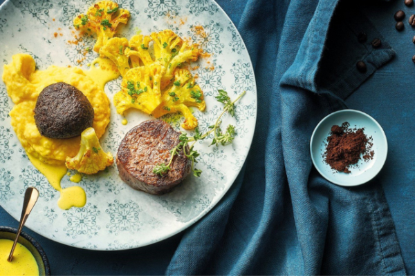 clarity_retailer_1 steak and eggs plated on a blue patterned plate