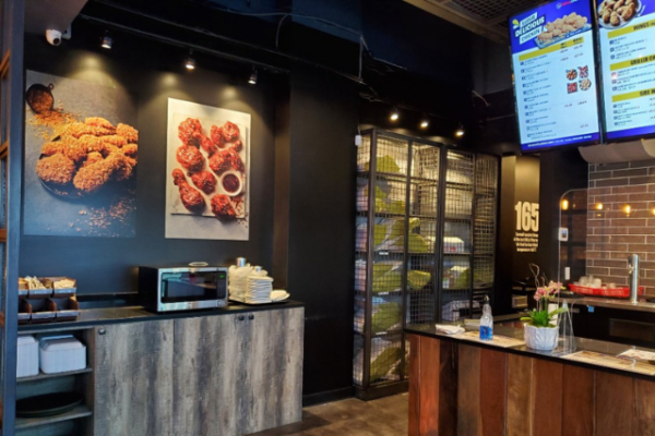 bb.q_3 bb.q restaurant interior image of checkout counter with digital menus behind the counter