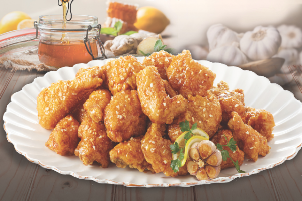 bb.q_2 honey garlic chicken wings on a white plate with a scalloped design